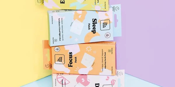 Vitamin patch packs labeled Energy, Sleep, Focus, and Day displayed on a pastel-colored background